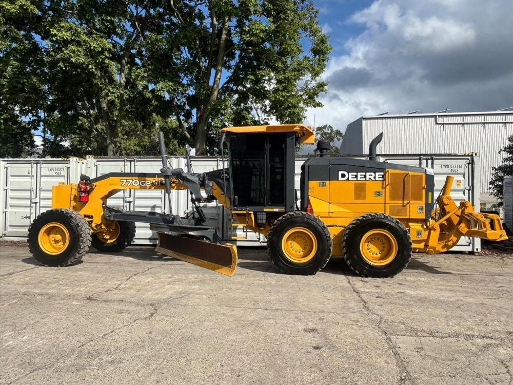 A yellow motor grader-1