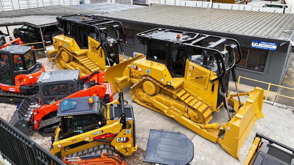 Some CAT and Kubota machinery in a yard