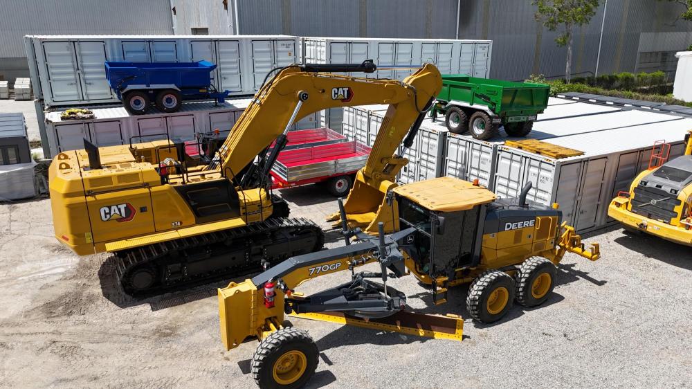 2 yellow machines in a yard